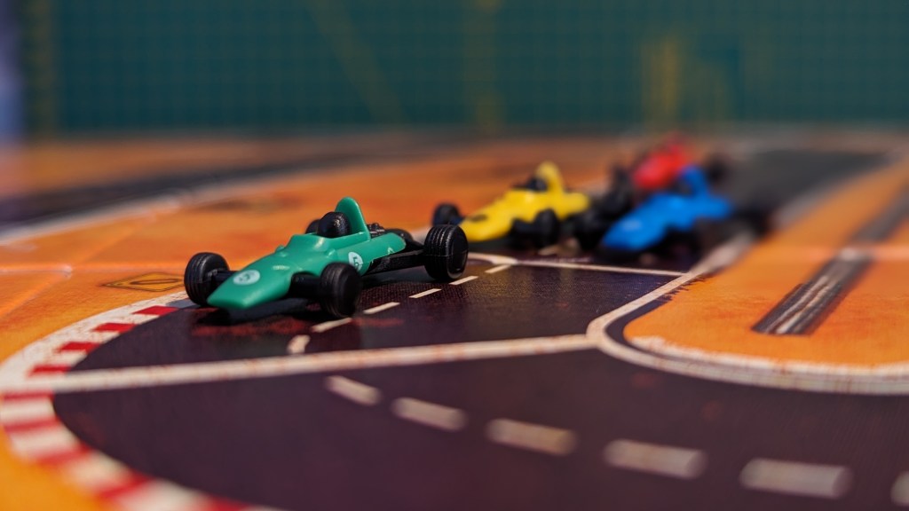 Four cars lined up ready to take the next corner in Heat: Pedal to the Metal.